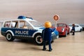 Playmobil figurines in scene representing police officers stoping car in traffic control