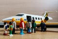 Playmobil figurines in scene representing travelers boarding a plane in the airport