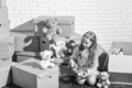 Playroom concept. Sweet home. Girl child relaxing after unpacking boxes. Moving in. Delivering service. Feeling good at Royalty Free Stock Photo