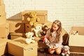 Playroom concept. Sweet home. Girl child relaxing after unpacking boxes. Moving in. Delivering service. Feeling good at Royalty Free Stock Photo