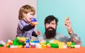 Playroom. father and son play game. little boy with bearded man dad playing together. child development. happy family in Royalty Free Stock Photo