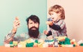 Playroom. father and son play game. little boy with bearded man dad playing together. child development. happy family in Royalty Free Stock Photo