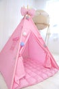 Playroom with Teepee. Modern room interior with play tent for child. pink wigwam