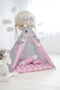 Playroom with Teepee. Modern room interior with play tent for child. pink wigwam