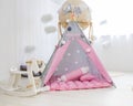 Playroom with Teepee. Modern room interior with play tent for child. pink wigwam