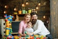 Playschool concept. Playschool kid play with mother and father. Happy family in playschool. Playschool education and