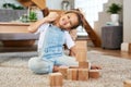 Playtime is the best time. Portrait of an adorable little girl playing with wooden blocks at home. Royalty Free Stock Photo
