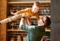 Happy little boy son playing with daddy at home, flying in air in fathers arms Royalty Free Stock Photo