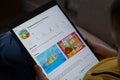 Playtime Island CBeebies app seen on the screen of ipad which is in the hands of unrecognisable child. App from BBC. Concept.