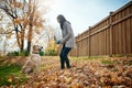 Playtime in the park with poochie me and my dog. an attractive young woman playing fetch with her dog on an autumn day Royalty Free Stock Photo