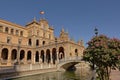 Historical buildings, archway and canal with bridgee on Plaza Espana, Seville