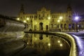 Plaza de EspaÃÂ±a in Seville, night scene after raining with long exposure photo and reflections of lights in water and cobbled Royalty Free Stock Photo