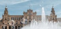 Plaza de EspaÃÂ±a in Seville peeking out from behind fountain of water with soap bubbles floating in air Royalty Free Stock Photo