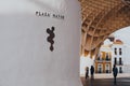 Plaza Mayor signs at the base of Metropol Parasol, Seville, Spain. Selective focus, people walk on background