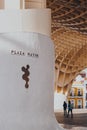 Plaza Mayor signs at the base of Metropol Parasol, Seville, Spain. Selective focus, people walk on background