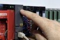 PLC - Programmable logic controller. Production automation. The hand points to the indicator LED.