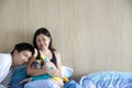 Pleasant asian couple sleeping while resting with their pug dog in bed Royalty Free Stock Photo