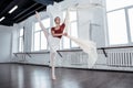 Pleasant attractive ballerina dancing alone in the hall