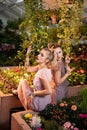 Pleasant attractive women standing under the plants Royalty Free Stock Photo