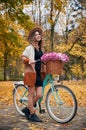 Beautiful girl outdoors with woman& x27;s retro bicycle. Royalty Free Stock Photo