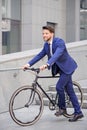 Pleasant businessman standing with bicycle Royalty Free Stock Photo