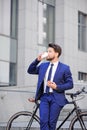 Pleasant businessman standing with bicycle Royalty Free Stock Photo