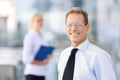Pleasant businessman standing near office Royalty Free Stock Photo