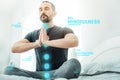 Pleasant calm man sitting and meditating. Royalty Free Stock Photo
