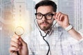 Pleasant clever doctor holding a stethoscope and touching his glasses Royalty Free Stock Photo