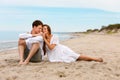 Pleasant couple of young lovers relax on the beach