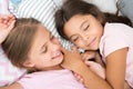 Pleasant dream on her mind. Girls fall asleep after pajamas party in bedroom. Girls have healthy sleep. Children relax Royalty Free Stock Photo