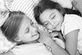 Pleasant dream on her mind. Girls fall asleep after pajamas party in bedroom. Girls have healthy sleep. Children relax