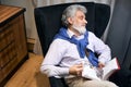 Pleasant elderly man dozing in a cozy chair Royalty Free Stock Photo