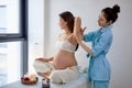 Pleasant Female Physiotherapist Massaging Back And Shoulders Of Pregnant Woman Royalty Free Stock Photo