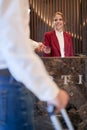 A pleasant female receptionist servicing a guest at the hotel. Tourism, business, hotel Royalty Free Stock Photo