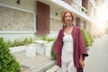 Pleasant ginger woman posing on street background.