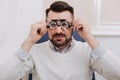 Pleasant good looking man holding eye examination glasses