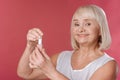 Pleasant good looking woman opening nail varnish