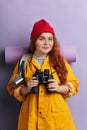 Pleasant good looking woman in stylish clothes holding her binoculars Royalty Free Stock Photo