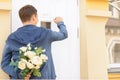 Pleasant guy holding flowers Royalty Free Stock Photo