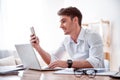 Pleasant handsome man sitting at the table Royalty Free Stock Photo