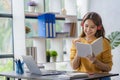 Pleasant happy young woman doing independent work using home computer Attractive woman studying online using laptop