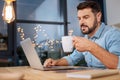 Pleasant hard working man enjoying his drink Royalty Free Stock Photo