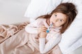 Pleasant ill girl lying in bed Royalty Free Stock Photo