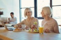 Joyful elderly women talking