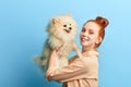 Pleasant kind cute girl holding her adorable pet