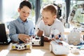 Pleasant little kids creating robots together Royalty Free Stock Photo