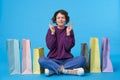 Pleasant looking young lovely short haired curly female raising hands with crossed fingers and smiling hopefully with closed eyes Royalty Free Stock Photo