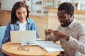 Pleasant man taking photo of printout while working with colleague Royalty Free Stock Photo