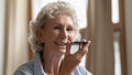 Pleasant mature female calling grandchild using voice dialing